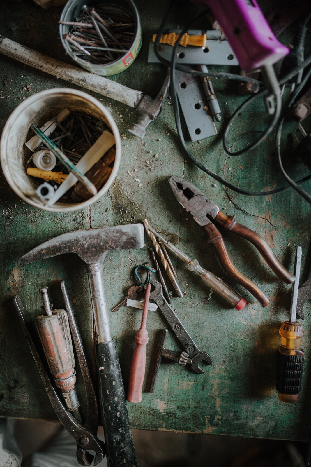 Hand tools and hardware on a workbench